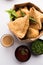 SamosaÂ Snack is an Indian deep fried pastry with a spiced filling usually made with potatoes, spices and herb